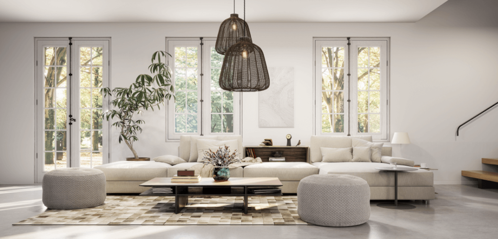 A bright living room with large windows, a creamy white sofa, natural wood furniture, woven pendant lights, and a soft patterned rug. The space feels warm and modern with neutral tones and simple decor, presented for a home listing by the best realtor to sell my house in denver